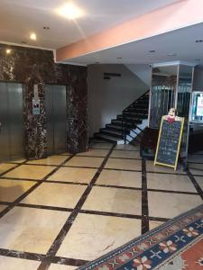 an empty lobby with stairs and a sign on the floor at STAYCITY OTEL in Altındağ