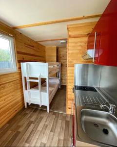 a small kitchen with a sink and a refrigerator at Lake View Lodge Pod in Chichester