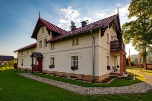 a large white house with a red roof at Dworek Wojanów in Wojanów