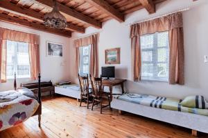 a room with two beds and a desk in it at Vila Jelita in Nida