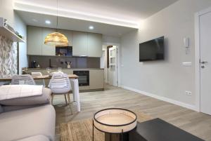 a living room and kitchen with a couch and a table at Apartamento rural Las Cañas Esencia de Bardenas in Villafranca