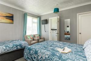 a bedroom with a bed with a book on it at Kenton in Newquay