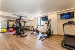 a gym with treadmills and exercise bikes in a room at KoSea Boutique Hotel in Kos +55 photos