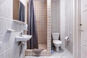 a bathroom with a toilet and a sink at Vila Jelita in Nida +30 photos