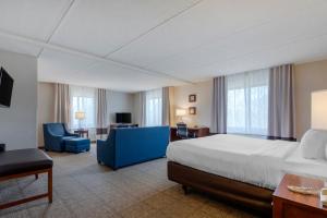 a large hotel room with a bed and a desk and chair at Comfort Inn The Pointe in Niagara Falls +37 photos