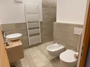 a bathroom with a white toilet and a sink at Cosy Apartment Marlain-Self Check in in San Valentino alla Muta