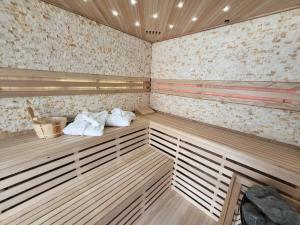 a sauna with white towels sitting on wooden shelves at Ferienhof Gutmichel in Feuchtwangen
