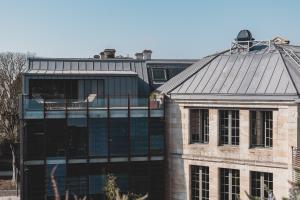a large brick building with a large window at Hotel La Zoologie & Spa Bordeaux in Bordeaux