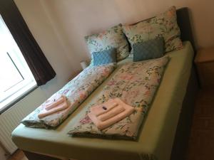 a bed with two towels and pillows on it at Apartment Peterl in Alpl