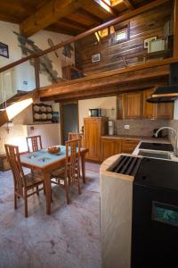 a kitchen with a table and chairs in a room at La Grandze in Allein