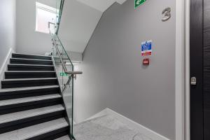 a staircase in a building with a glass door at StayInn Aldgate in London