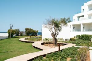 a park with a tree and a building at Can Salia in San Antonio Bay
