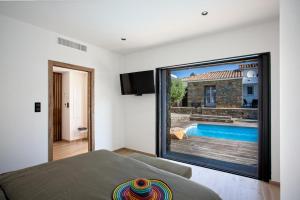 a bedroom with a large window with a swimming pool at Casa Lina in Borgo