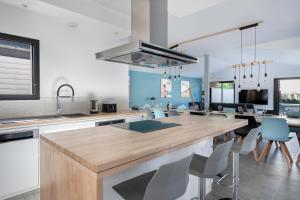 a kitchen with a wooden counter top in a room at Villa moderne avec piscine pour 15 personnes ! in Saint-Gildas-de-Rhuys