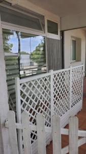 a porch with two chairs and a view of the water at Residenza La Gazza e Spiaggia in Cervia