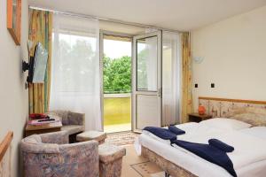 a bedroom with a bed and a large window at Retro Lido - Vonyarcvashegy in Vonyarcvashegy +31 photos