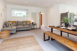 a living room with a couch and a table at No 5 Highwayman - Norfolk Cottage Agency in Sheringham