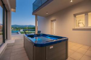 a jacuzzi tub in a room with a view at Villa Lukrecia, Luxury Villa in Imotski-Makarska in Donji Proložac