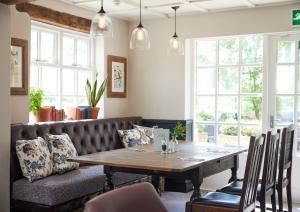 a dining room with a table and a couch at Rose Revived by Chef & Brewer Collection in Witney