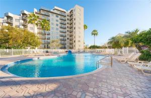 a swimming pool in front of a building at Universal Family Fun Perfectly Located + amenities in Orlando