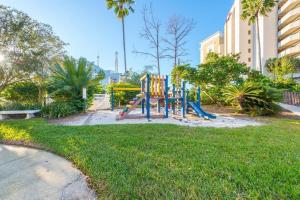 a playground in a park next to a building at Universal Family Fun Perfectly Located + amenities in Orlando