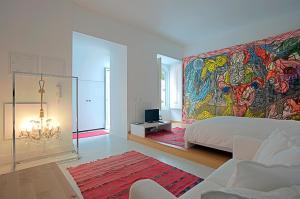 sypialnia z dużym obrazem na ścianie w obiekcie Portas do Castelo Apartments w Lizbonie