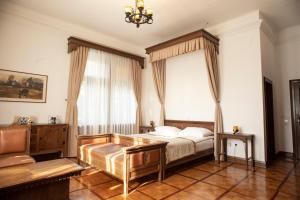 a bedroom with a bed and a large window at VILA HERBERSTEIN in Velenje