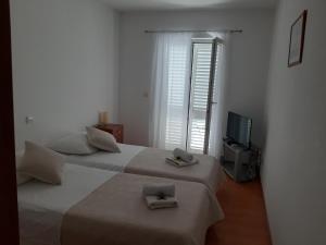 Postel nebo postele na pokoji v ubytování Apartments T & D