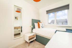 a bedroom with a bed and a window at Anchored - Stunning Home in connected rural setting in Bishopton