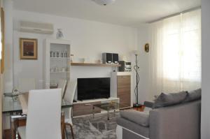 a living room with a couch and a flat screen tv at Apartmaji Štamcar in Izola