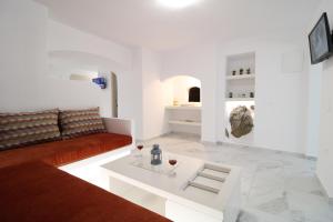 a living room with a couch and a coffee table at Plaka Philoxenia Apartments in Plaka Milou