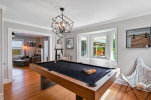 a living room with a pool table at Historic Waterfront estate With Yard & Modern Kitchen in Lake Worth