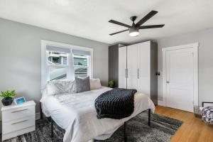 a bedroom with a bed and a ceiling fan at Historic Waterfront estate With Yard & Modern Kitchen in Lake Worth