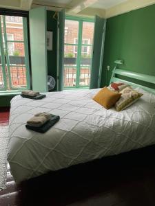 a bedroom with a large bed with two towels on it at B&B Suupmarkt in Dokkum