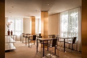 a dining room with tables and chairs and a window at BYPILLOW The Bloom in Girona