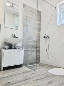 a white bathroom with a sink and a shower at Apartman Marijana in Pakoštane +20 photos