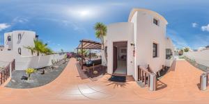 a white house with a ramp in front of it at Villa Alba Deluxe & Spa Pool in Playa Blanca
