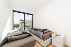 two beds in a room with a window at Casa do Sol - By SCH in Salir de Porto +26 photos