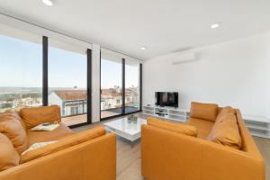 a living room with two couches and a tv at Casa do Sol - By SCH in Salir de Porto