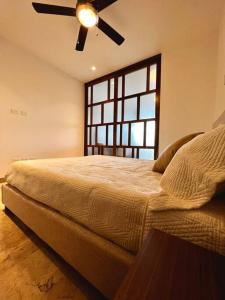 a bedroom with a large bed and a window at Ipana C306 in Playa del Carmen