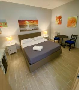拿坡里的住宿－多莫斯2號旅館，一间卧室配有一张床、两把椅子和一张桌子