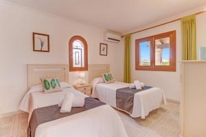 a room with two beds and a window at Villa Bauza by Villa Plus in El Port +14 photos