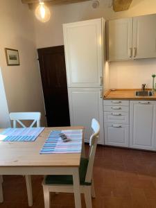 a kitchen with a table and a table and chairs at In piazza Casale Marittimo in Casale Marittimo