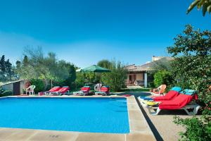 - un groupe de chaises et une piscine dans l'établissement Villa Garriguer by Villa Plus, à El Port