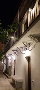 a wall with a bench and lights on it at Le Altezze in Erice