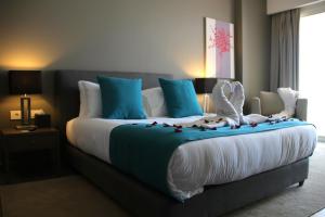 a bedroom with a large bed with blue and white at Pangea Beach Resort in Jiyeh