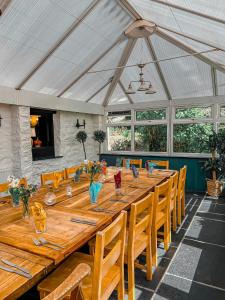 a large wooden table in a room with chairs at The Crown Inn in Lanlivery