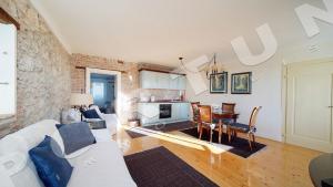 a living room with a white couch and a table at Villa Augusta Ferri in Rovinj
