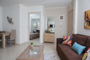 a living room with a couch and a table at Anemone City Center Apartment in Heraklio +6 photos