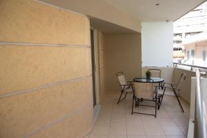 a balcony with a table and chairs in a room at Anemone City Center Apartment in Heraklio